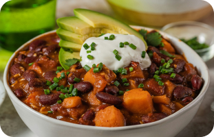 Bowl of chili sin carne served with rice and fresh toppings.