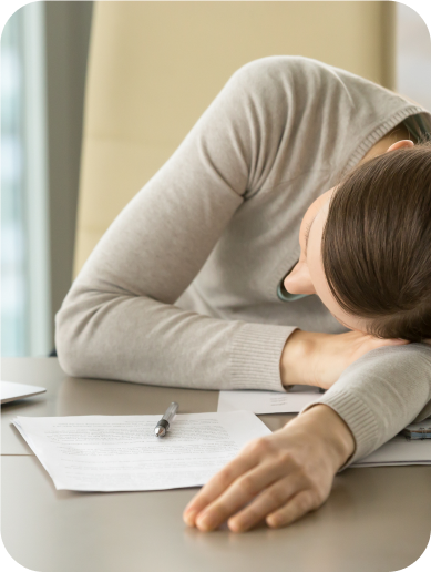 Person with Myasthenia Gravis experiencing fatigue, resting on desk