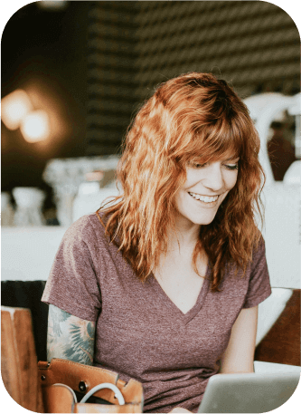 Woman working on a laptop and maintaining health at work with Myasthenia Gravis