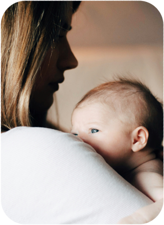 Mother holding her baby, navigating motherhood with Myasthenia Gravis
