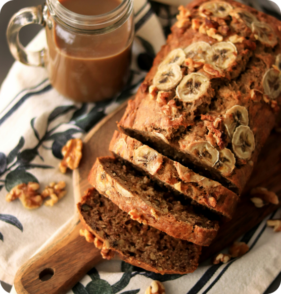 Sliced Myasthenia Gravis-friendly banana bread with nuts, served with a cup of coffee